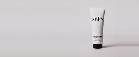 Salo Remineralizing Cleanser tube on a soft grey studio backdrop
