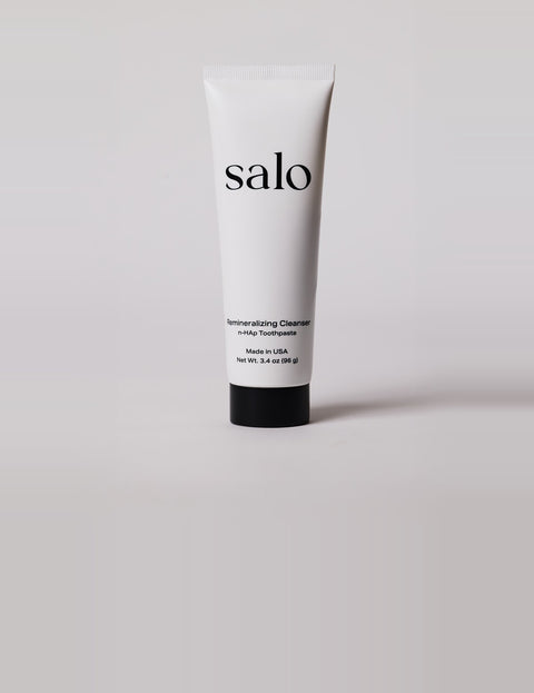 Salo Remineralizing Cleanser tube on a soft grey studio backdrop