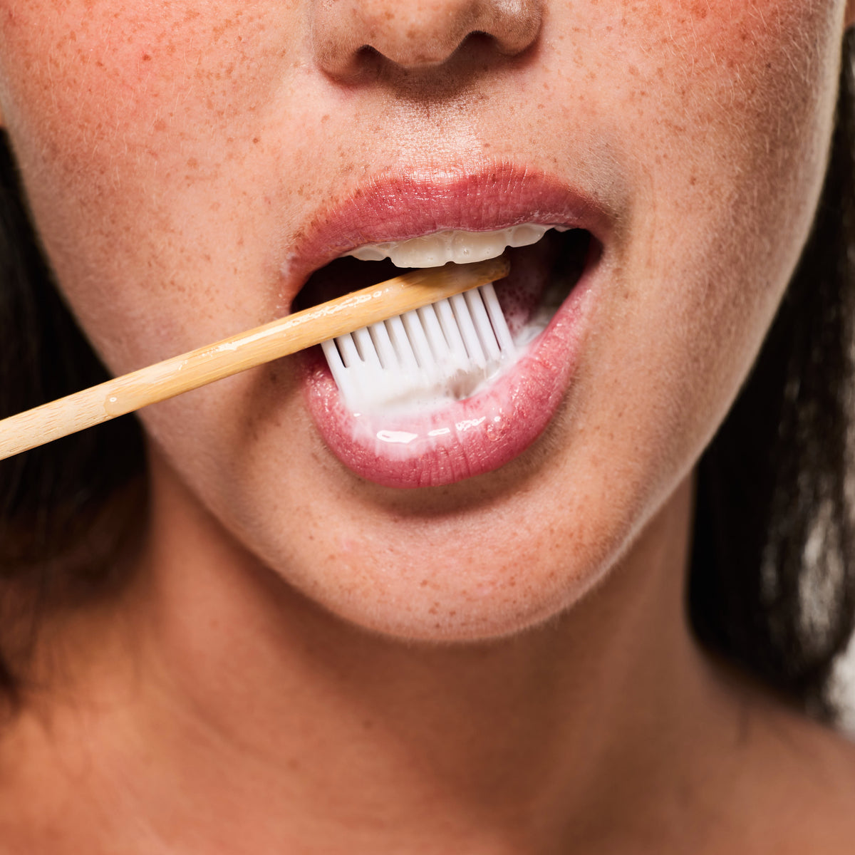 Brushing with the Salo Remineralizing Cleanser on a bamboo toothbrush